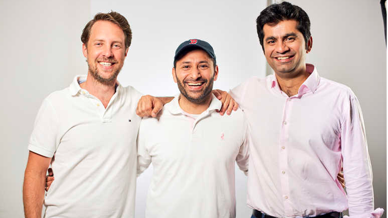 Three men (Careem's co-founders) standing in a line with arms on one another's shoulders, smiling, as they managed the pressures of rapid scaling