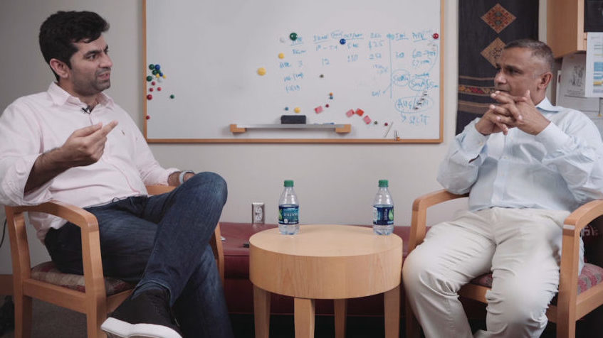 Two people seated in chairs, discussing the challenges CEOs of rapidly scaling startups face